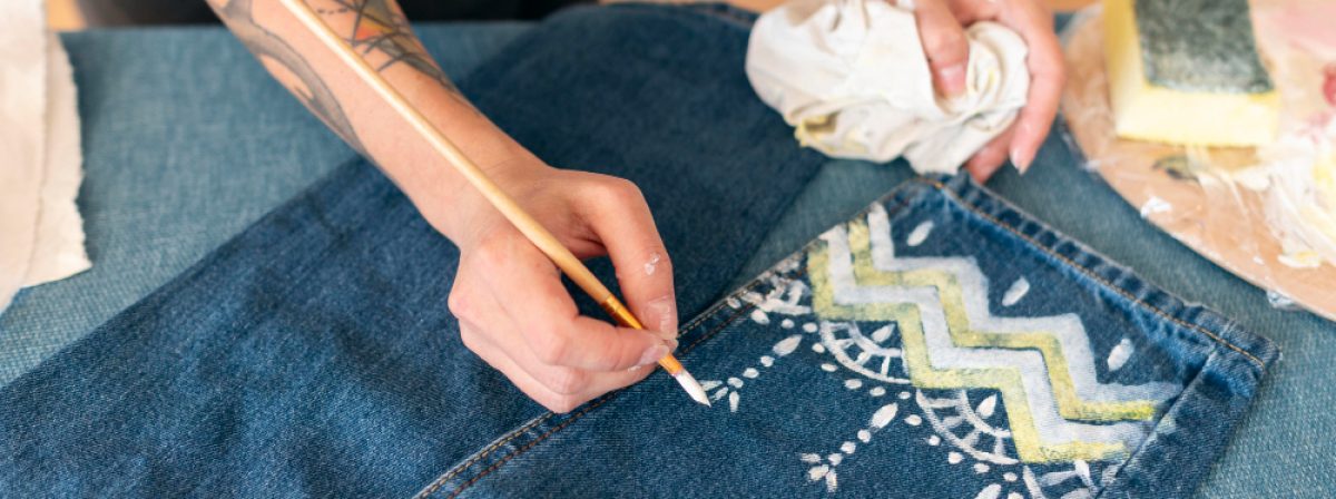 close-up-woman-painting-jeans